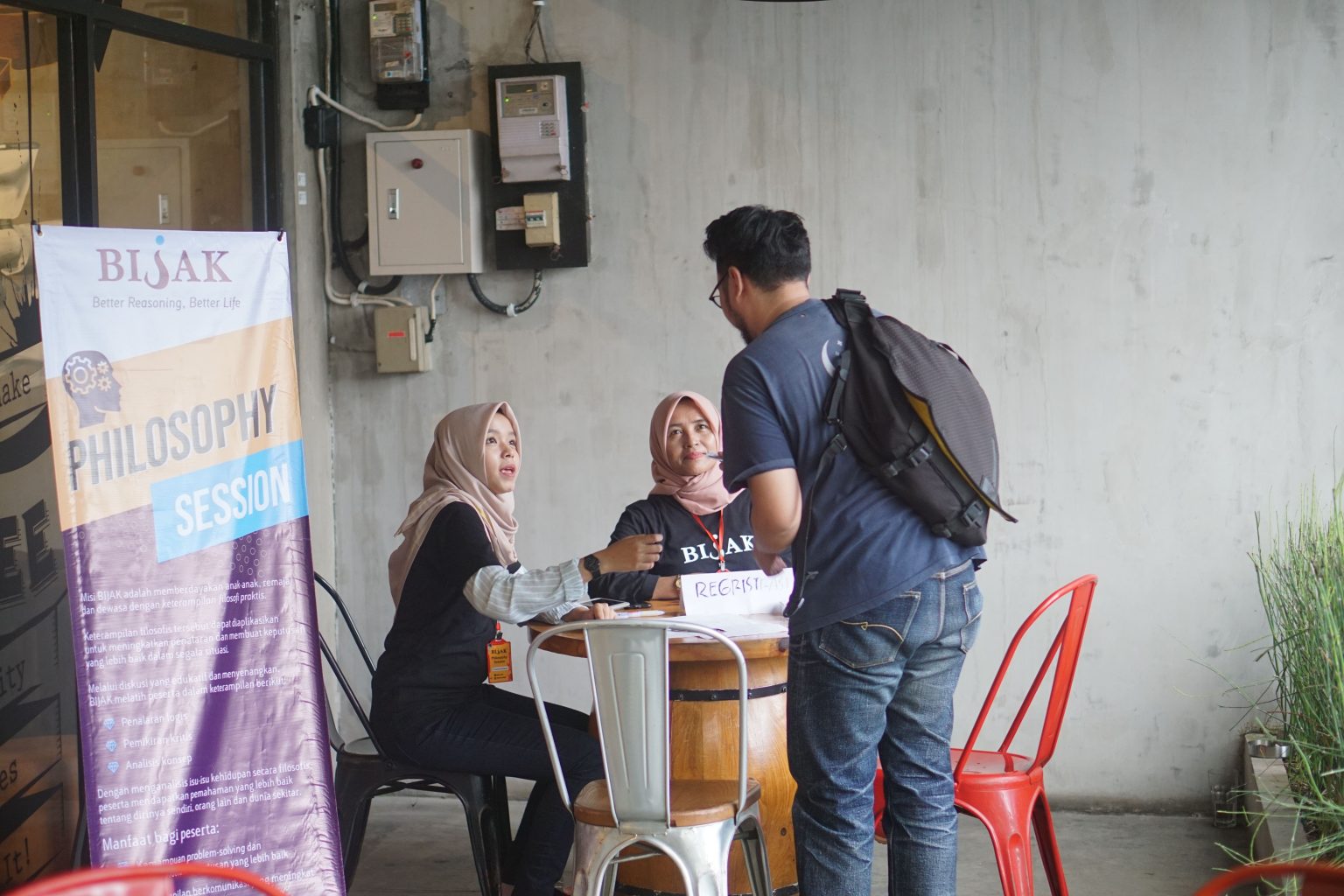 Puspa and Bu Ani at the registration counter.