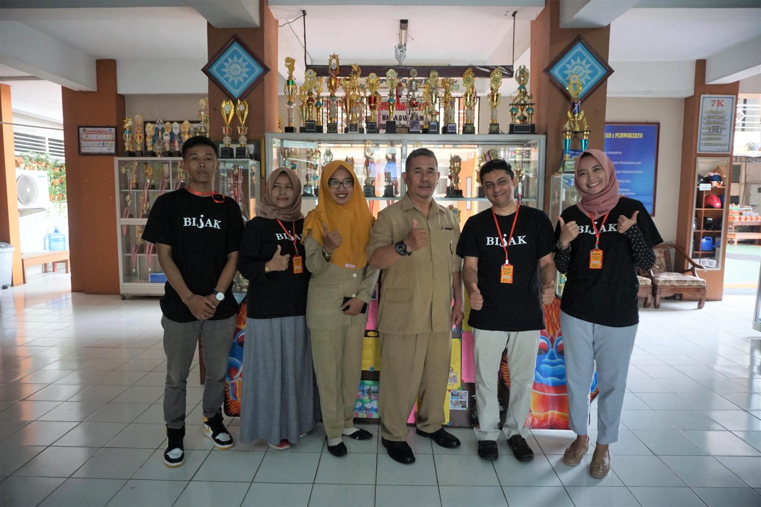 School principal and teacher poses with the BIJAK team.